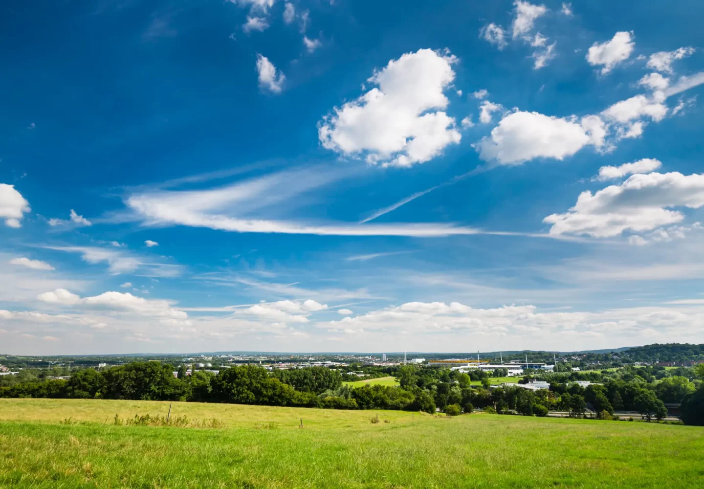 Aachen Overview With Deep Blue Sky Panoramic view from Berensberg down to the northern parts of Aachen with a meadow in the foreground, the Tivoli stadium in the center and the A4 motorway and the Lousberg to the right.